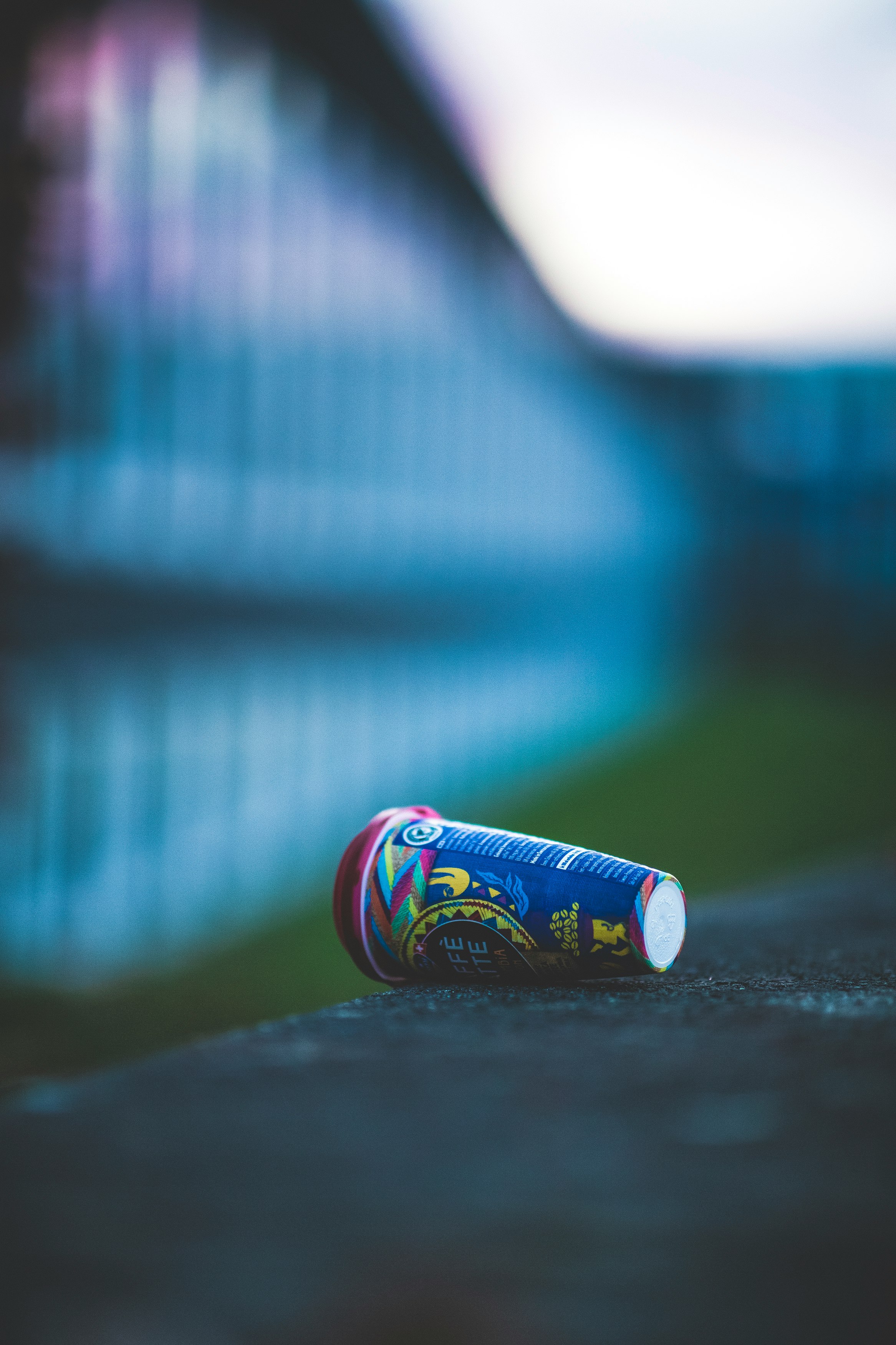 blue and red can on black table